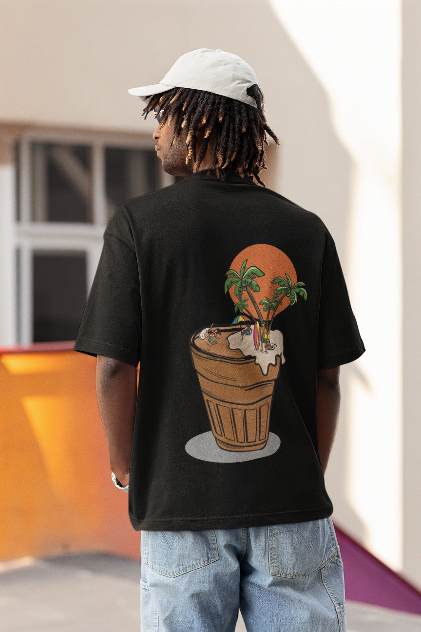 Model wearing a black oversized tshirt with an illustration of a cup of chai with people surfing and chilling, indian streetwear, desi designs