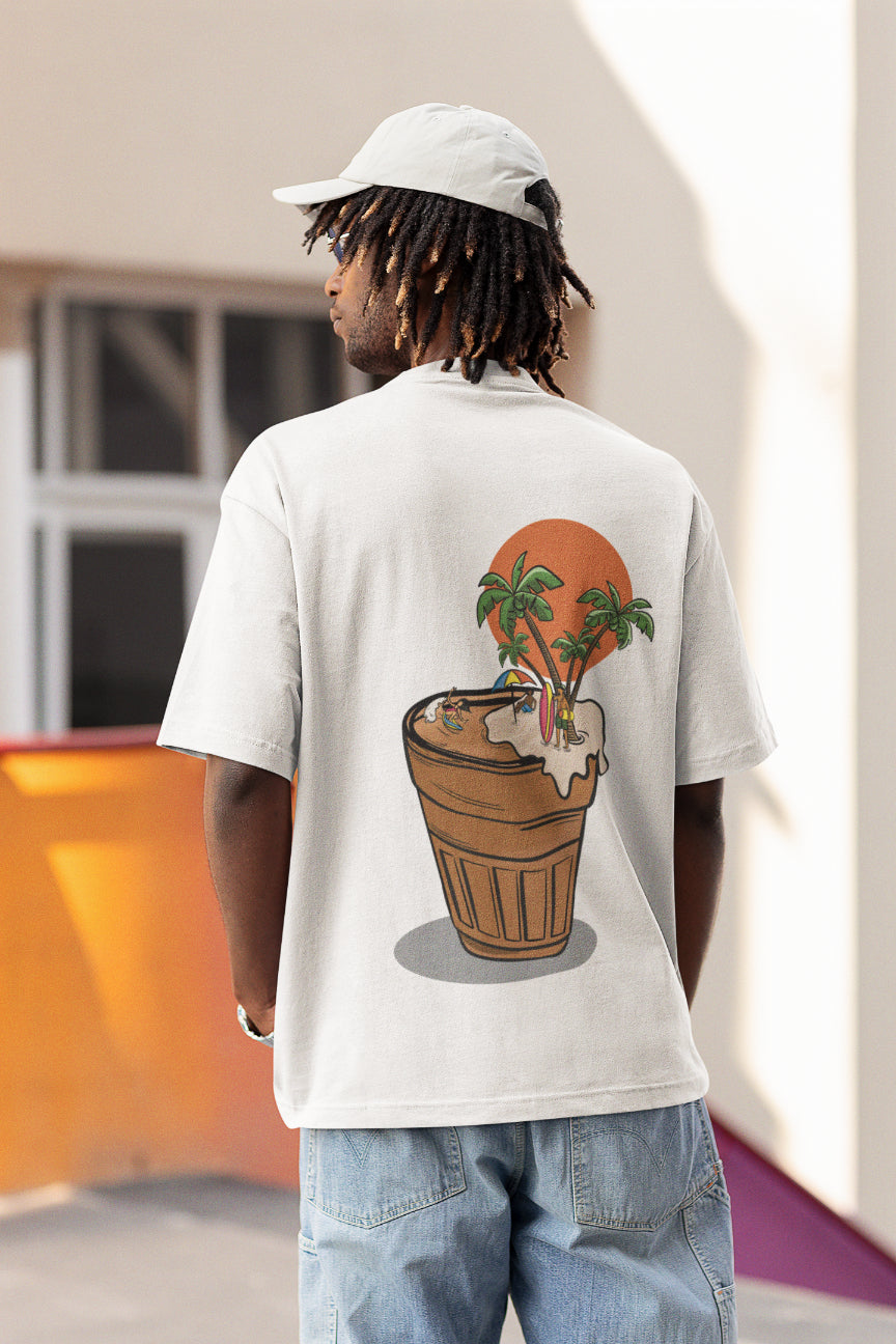 Model wearing a white oversized tshirt with an illustration of a cup of chai with people surfing and chilling, indian streetwear, desi designs