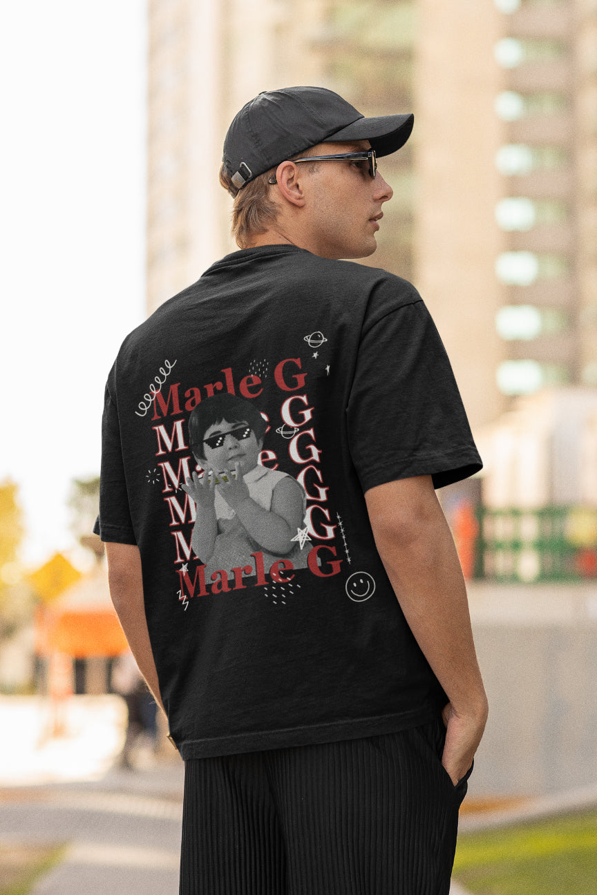 A black oversized tshirt with the text "marle g", indian streetwear, desi designs, stoner wear