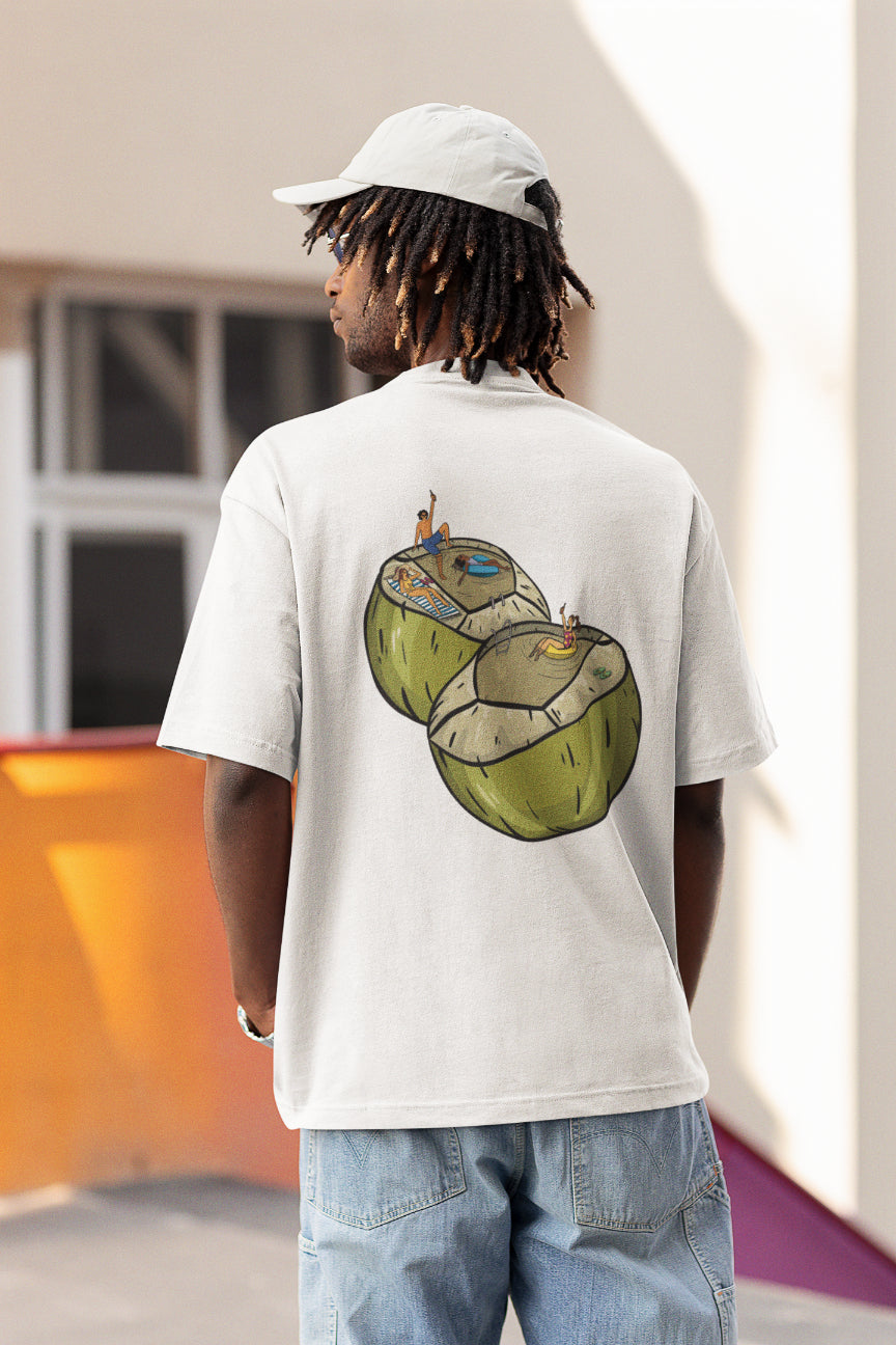 A model in a white oversized tshirt with the illustrations of coconuts with people chilling and swimming inside the coconut water, indian streetwear, desi designs,